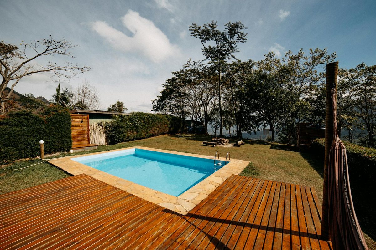 Rectangular backyard pool with a wood deck - fiberglass pool resurfacing in Cape Coral, FL