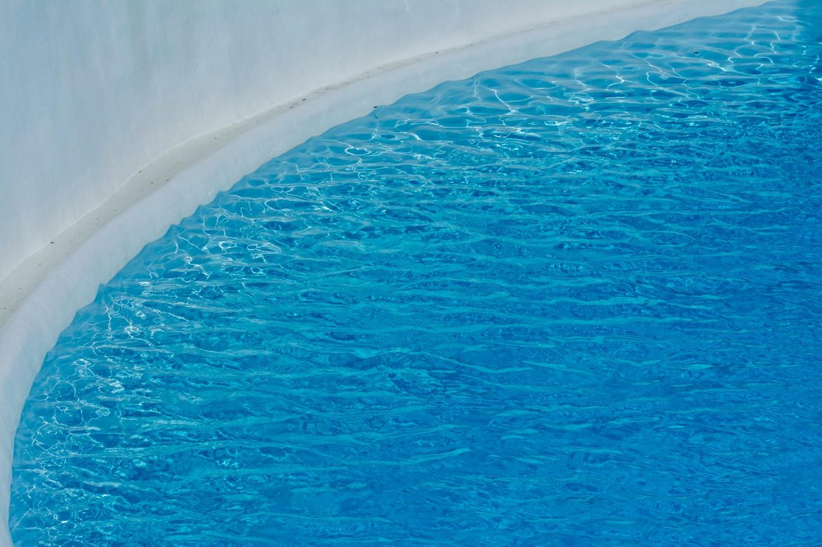 Fresh white plaster pool finish under clear blue water - plaster pool resurfacing in Cape Coral, FL